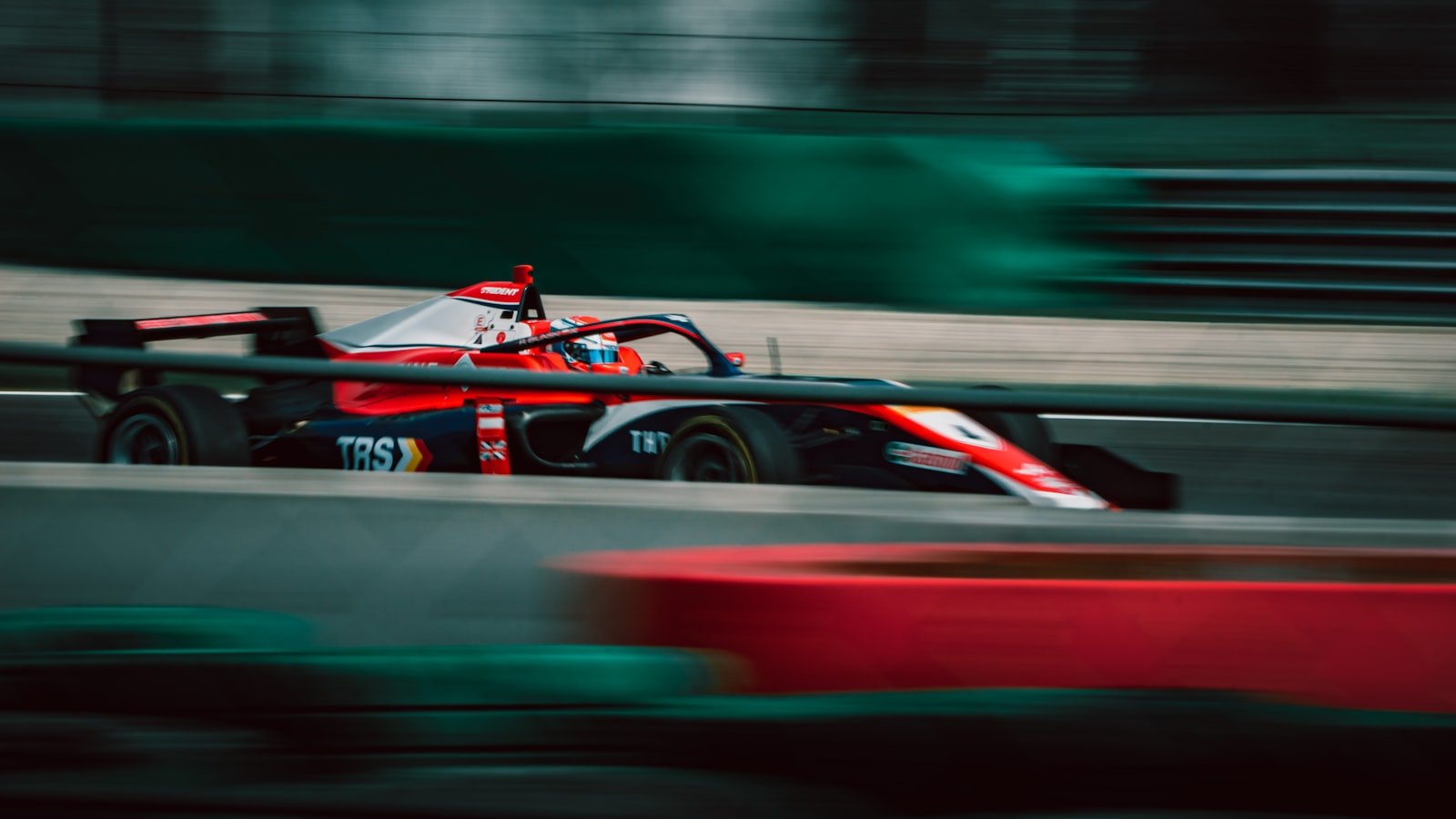 Formula 1 car at speed under lights